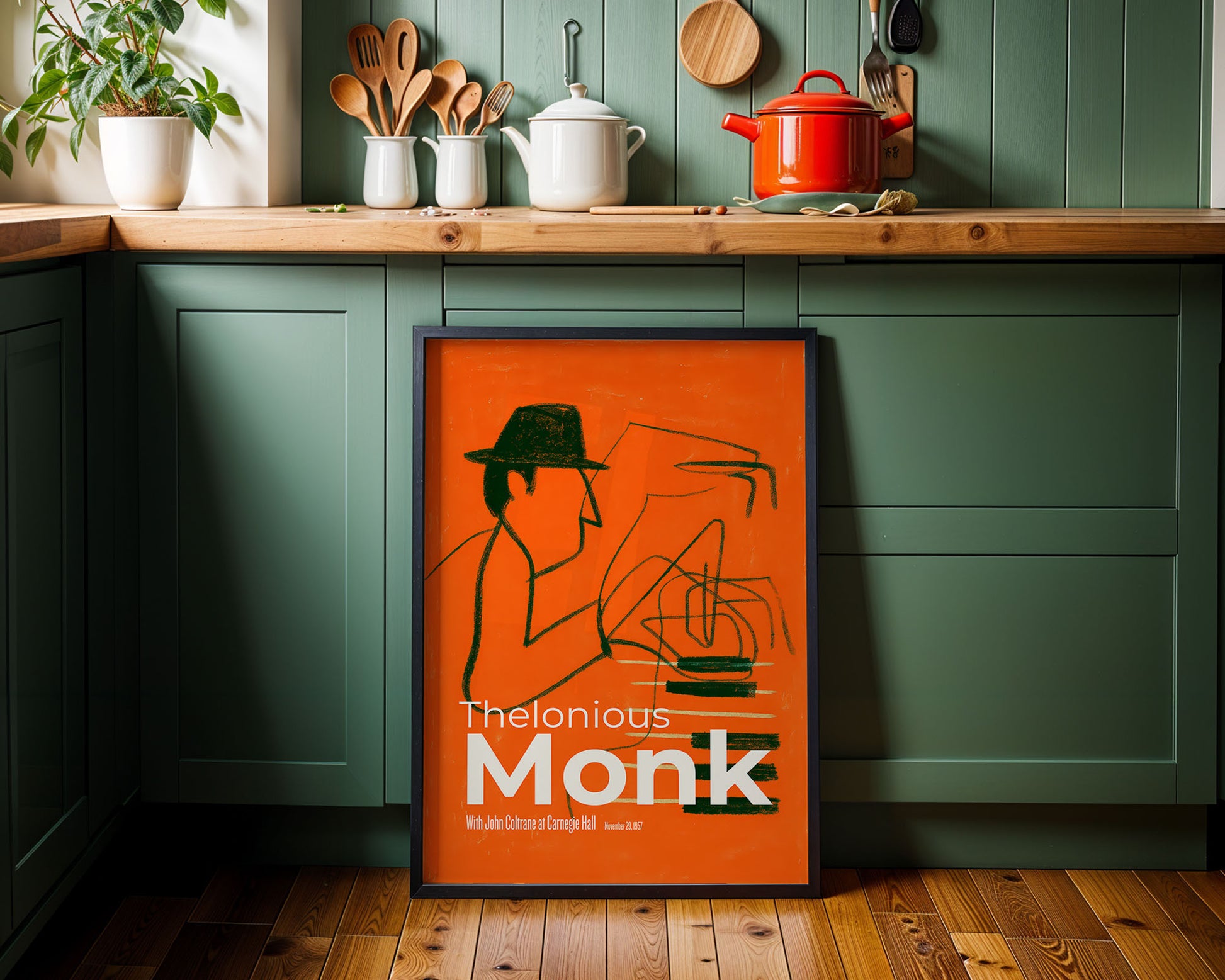 Framed poster of Thelonious Monk in a kitchen with green cabinets and wooden countertops.