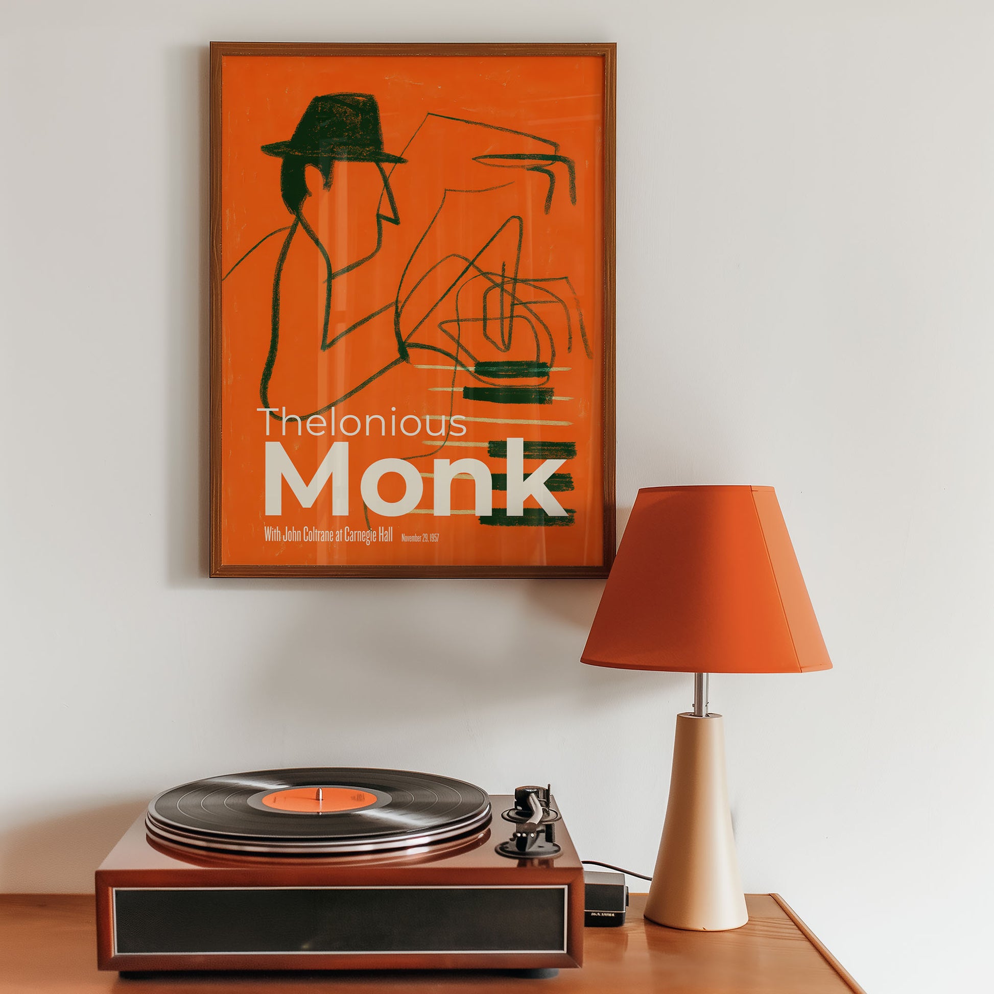 Vintage turntable with a 'Thelonious Monk' poster on a wall.