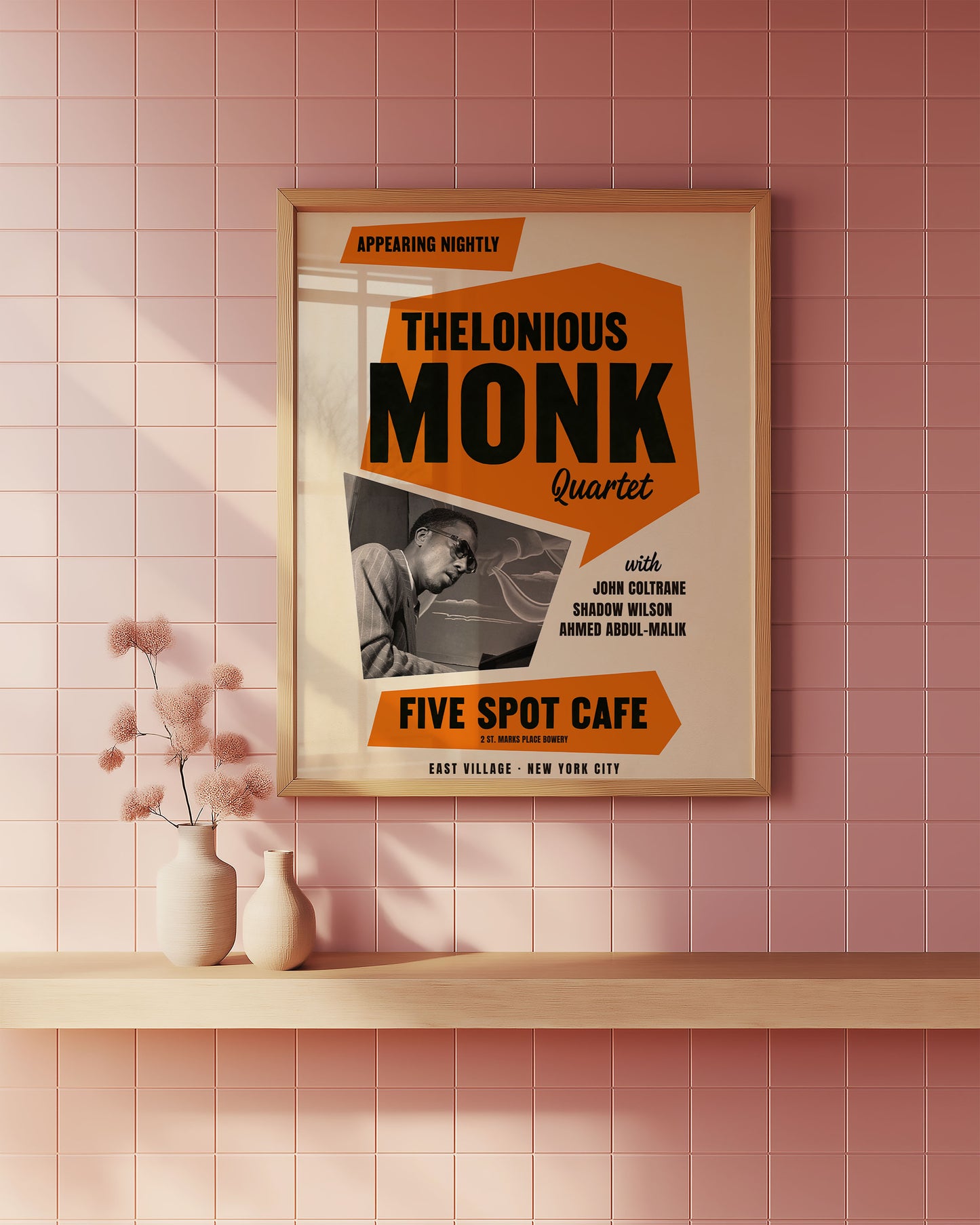 Framed poster of Thelonious Monk Quartet at Five Spot Cafe on a pink tiled wall.