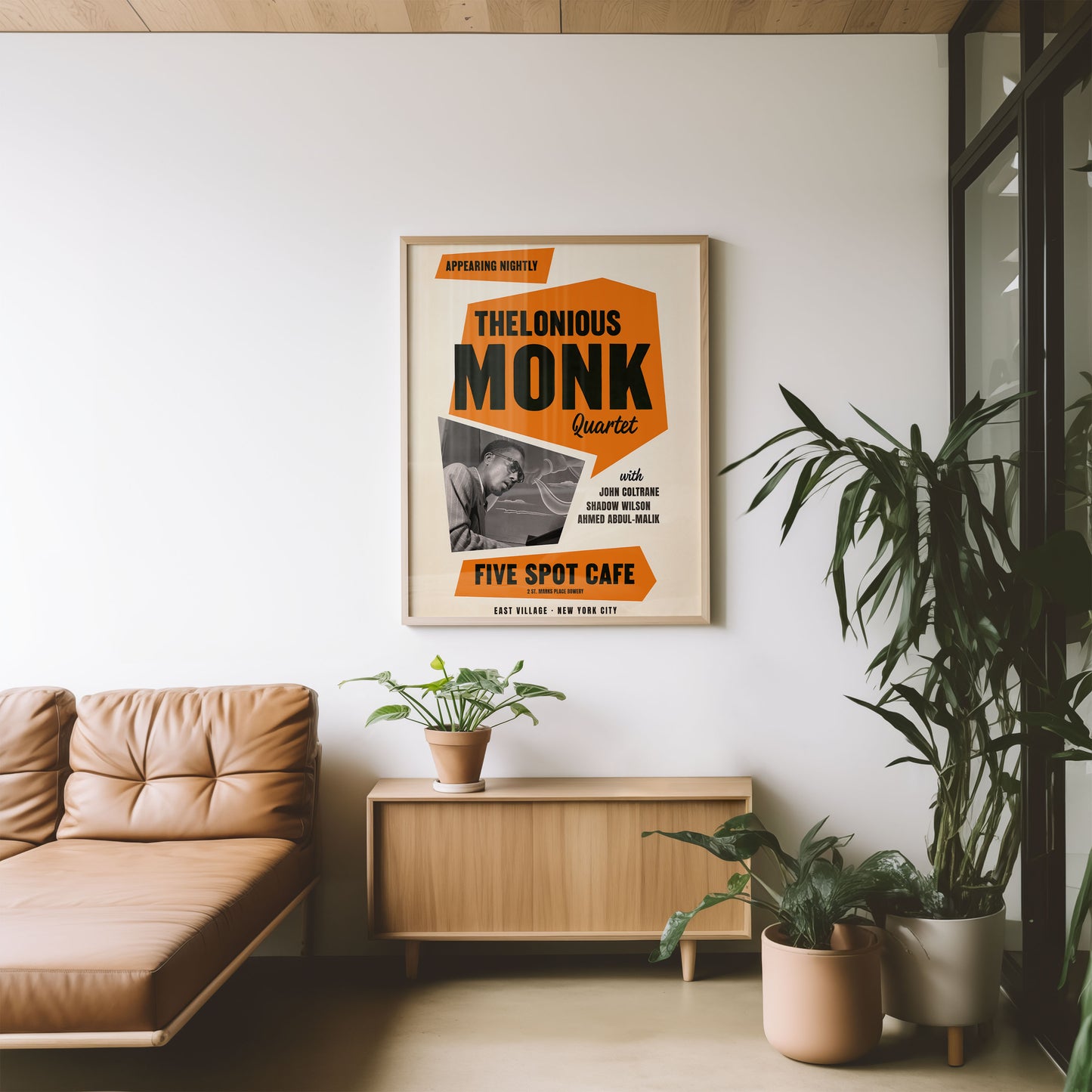 dopamine decor art print of Thelonious Monk  in a living room with a beige sofa and plants.