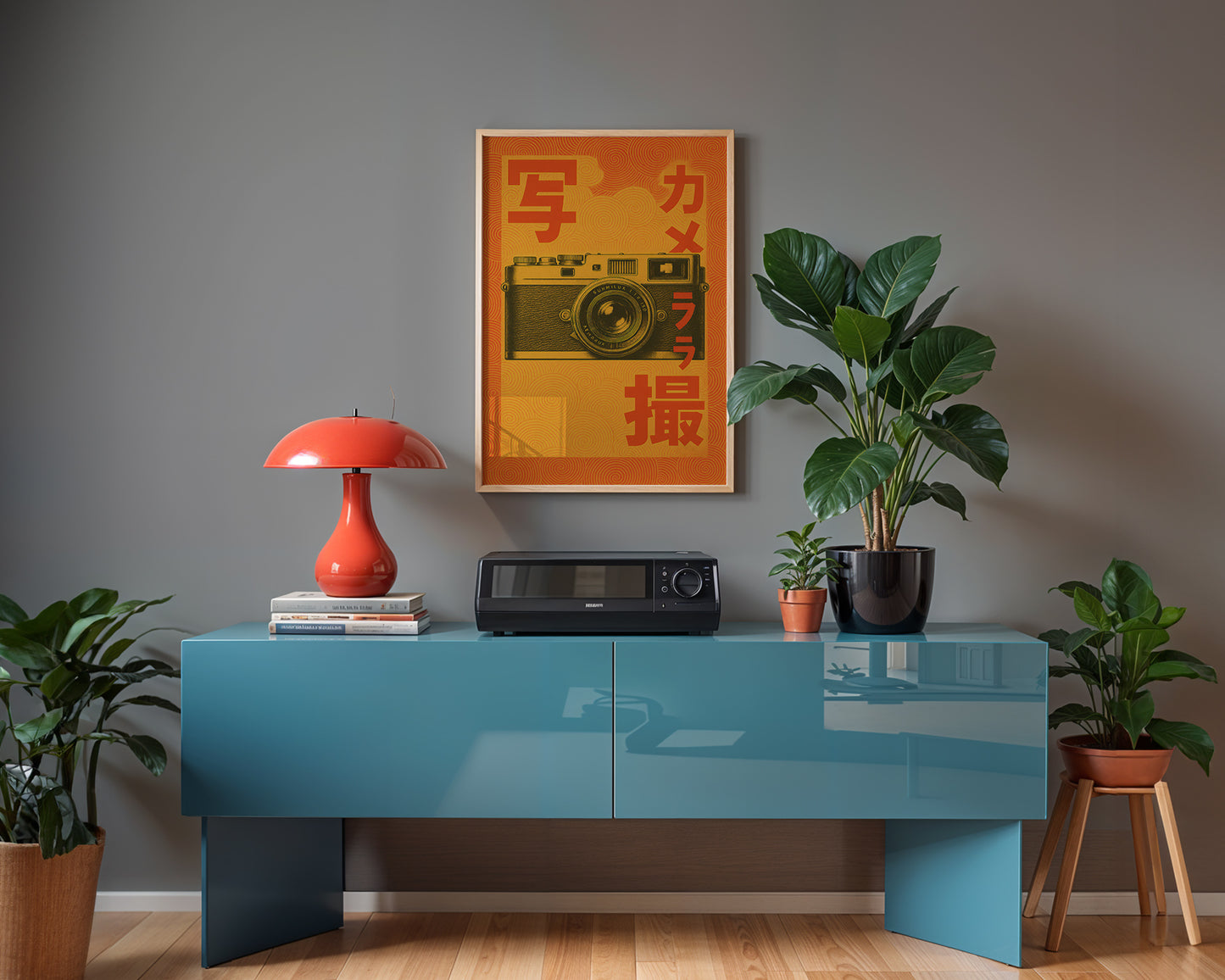 Modern studio interior with a blue hi-fi table, red lamp, and decorative items against a gray wall.