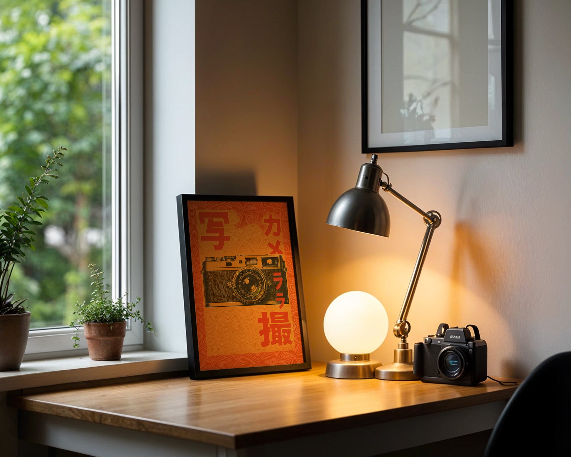 Desk with lamp, camera, and framed picture next to a window with plants.