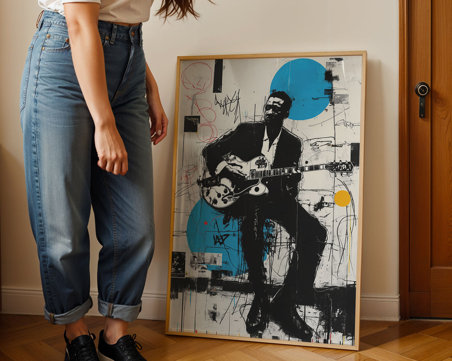 Person standing next to a framed artwork of a musician playing guitar.