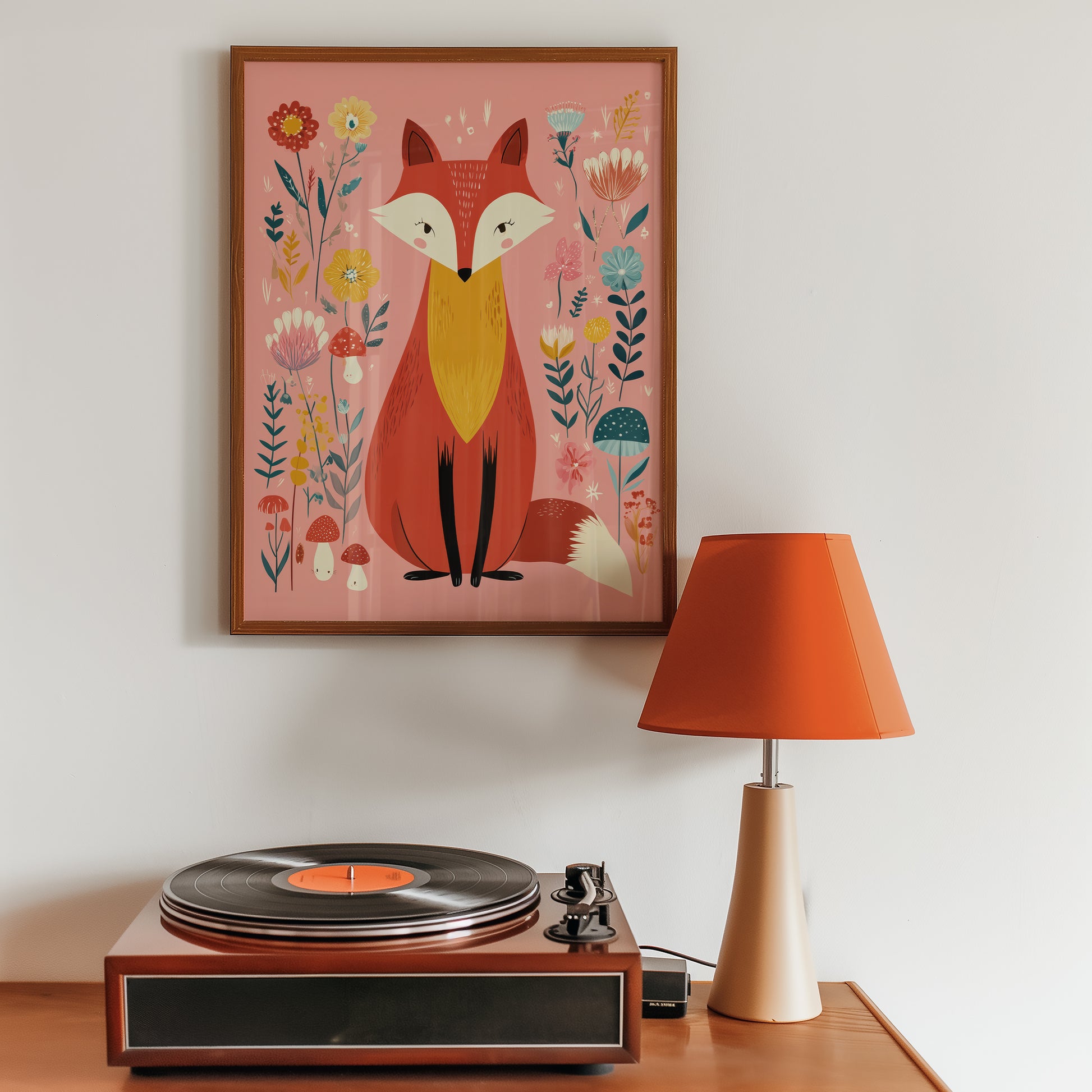 Framed artwork of a fox with flowers above a record player on a wooden surface.