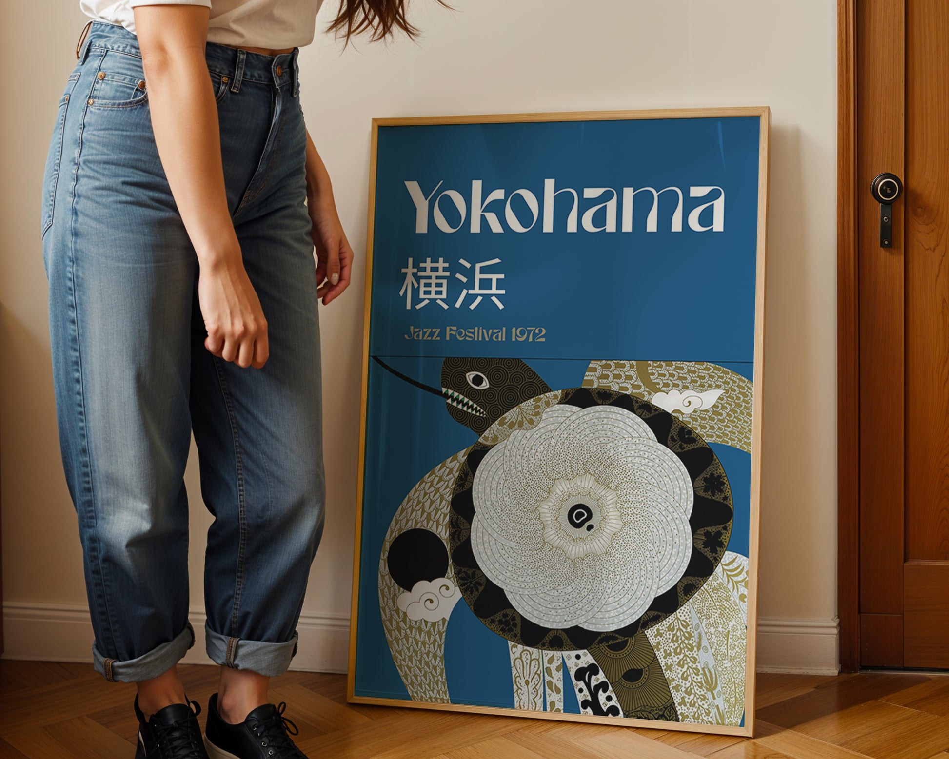 woman standing next to a framed japanes art poster in a living room. 